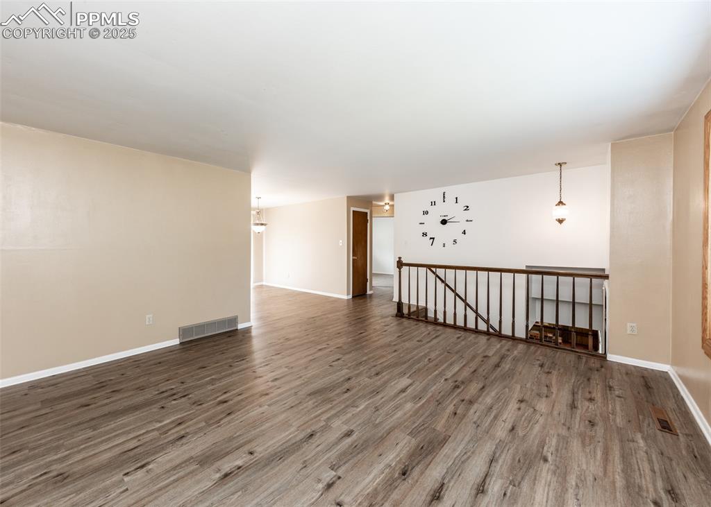Image 5 of 22: Spare room with wood finished floors and baseboards