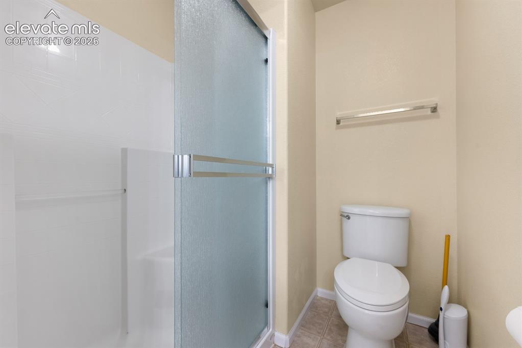 Image 19 of 33: Shower enclosure with frosted glass sliding doors, integrated white wall su