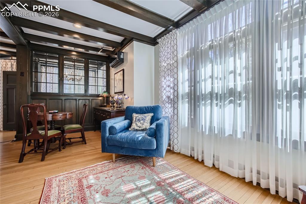Image 21 of 49: Living area with a wall mounted air conditioner, light hardwood / wood-styl