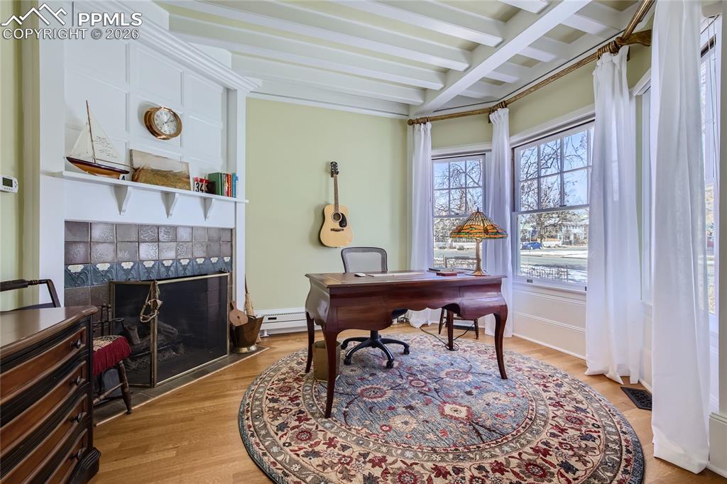 Image 22 of 49: Office space with a baseboard radiator, light hardwood / wood-style floors,