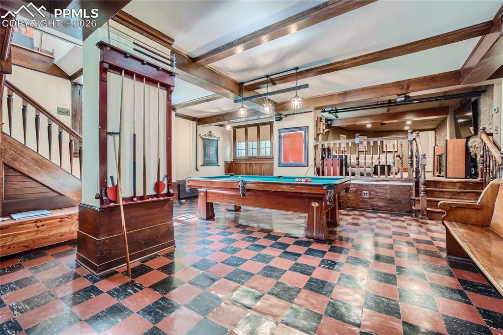 Image 24 of 49: Playroom featuring beam ceiling, pool table, and dark tile floors