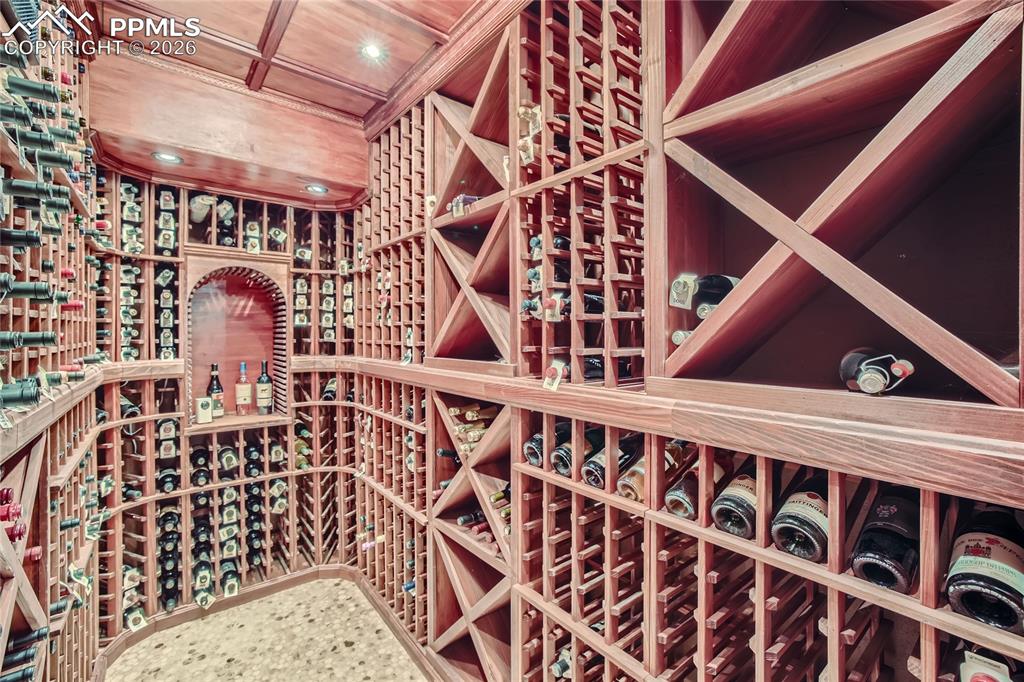 Image 27 of 49: Wine room featuring wooden ceiling