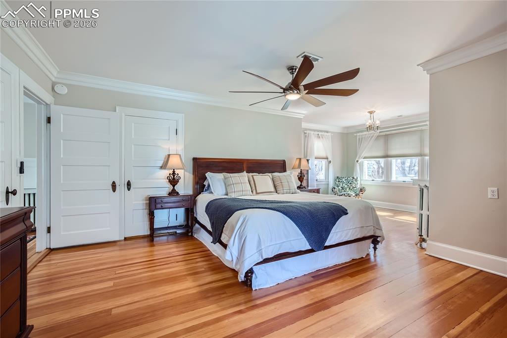 Image 29 of 49: Bedroom featuring ornamental molding, ceiling fan, and light hardwood floor