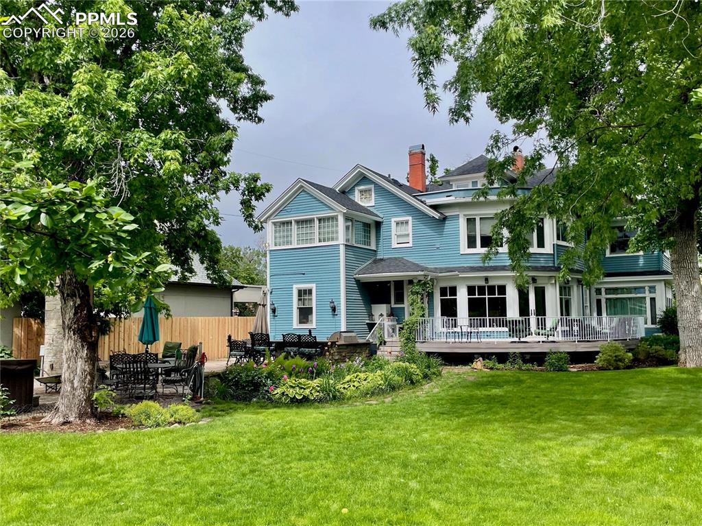 Image 3 of 49: Back of property with a yard