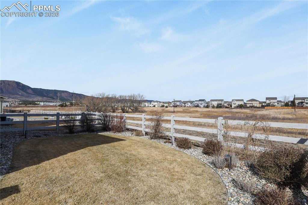 Image 26 of 27: Backing to open space, the setting provides added privacy and a peaceful ba