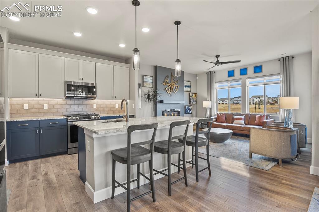 Image 4 of 27: The kitchen is thoughtfully designed with a center island and eating bar, q