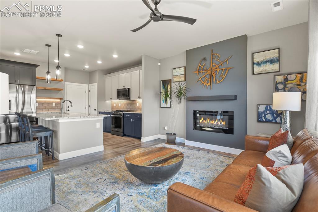 Image 9 of 27: Opens seamlessly to the kitchen and dining areas