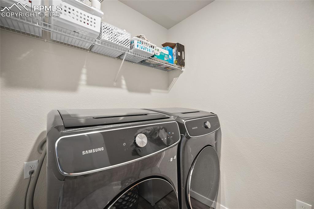 Image 11 of 41: Laundry area with washer and clothes dryer