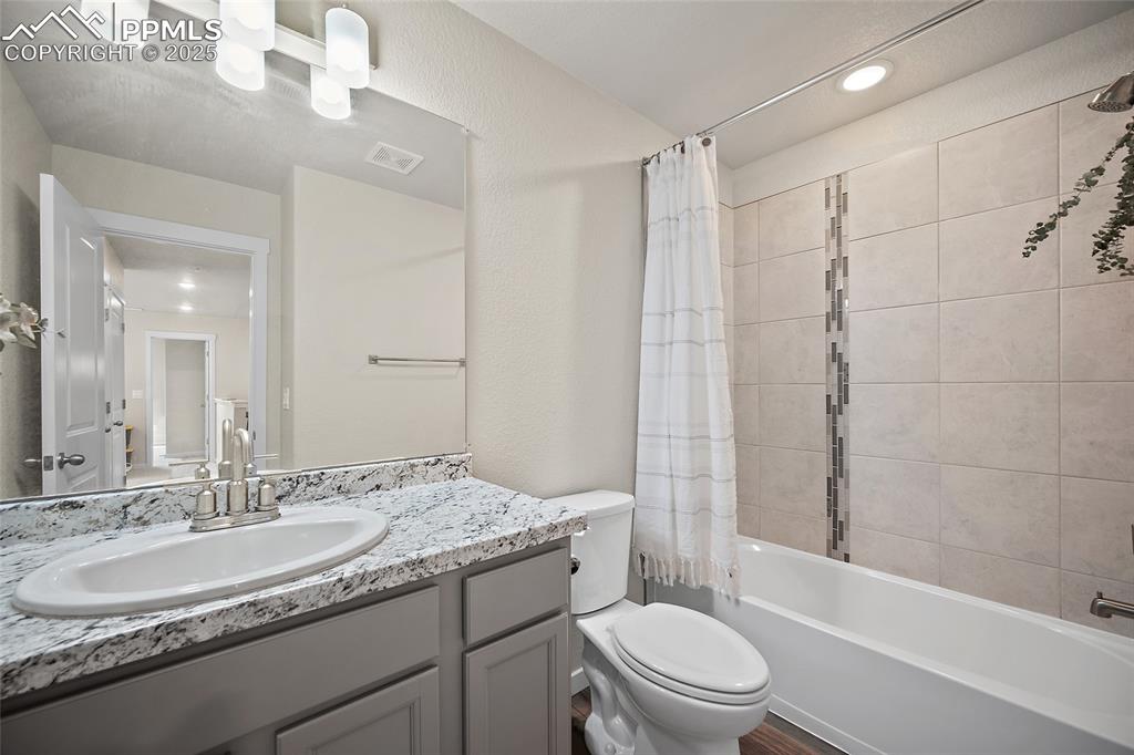 Image 12 of 41: Full bath with vanity and shower / bathtub combination with curtain