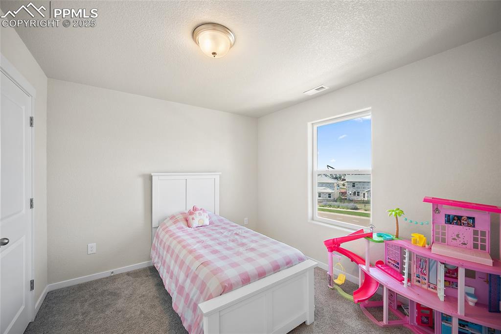 Image 13 of 41: Carpeted bedroom featuring a textured ceiling