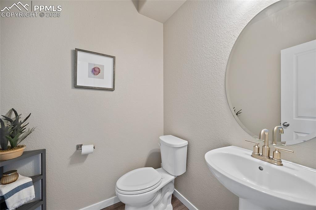 Image 16 of 41: Bathroom with toilet and wood finished floors