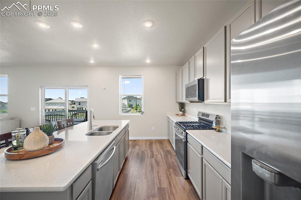 Image 19 of 41: Kitchen featuring appliances with stainless steel finishes, healthy amount