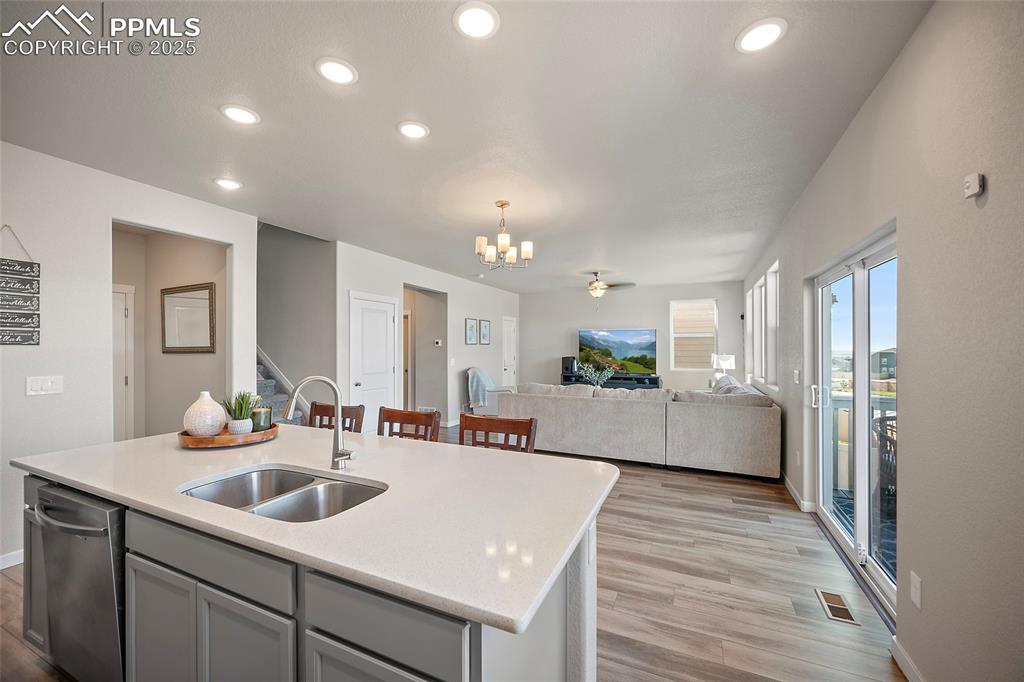 Image 21 of 41: Kitchen featuring a chandelier, light countertops, open floor plan, light w
