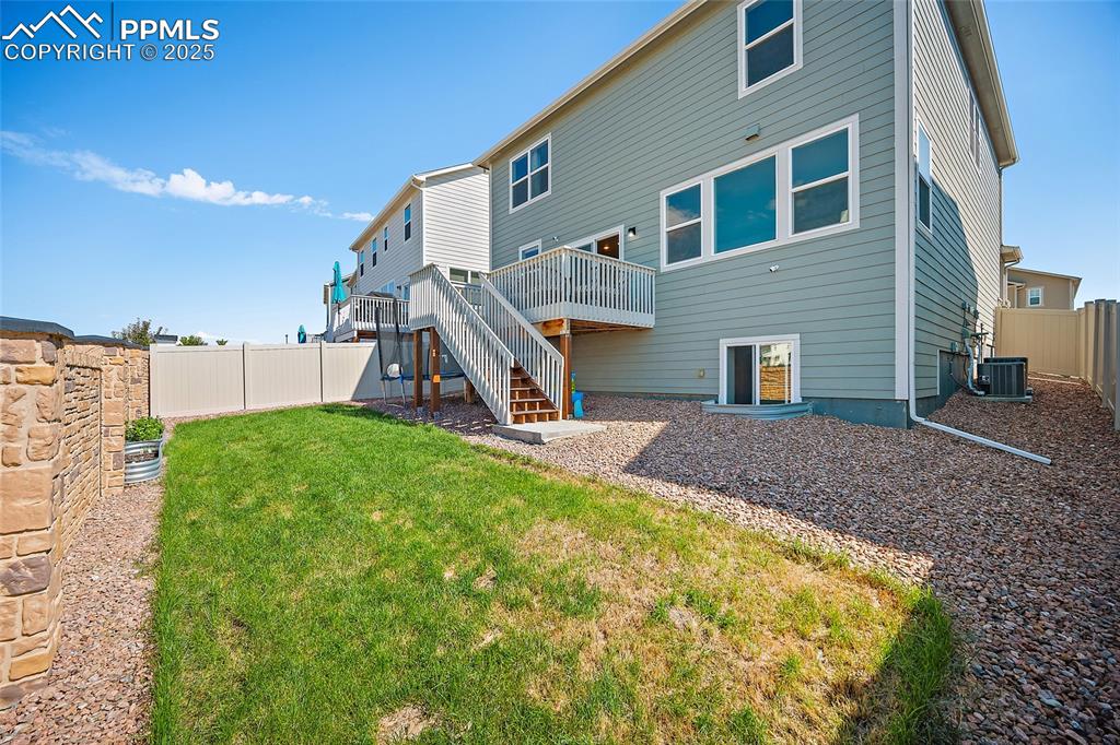 Image 30 of 41: Back of property with stairway and a deck