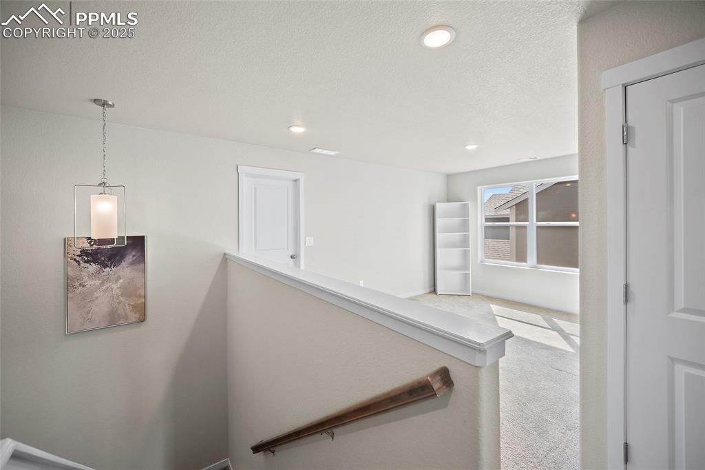 Image 5 of 41: Stairs featuring carpet floors, recessed lighting, and a textured ceiling