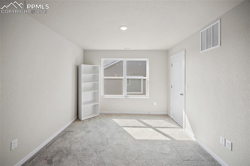 Image 6 of 41: Unfurnished room with carpet and baseboards