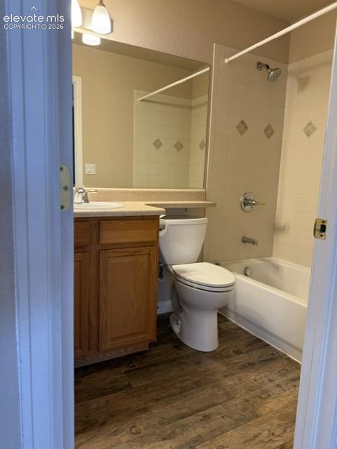Image 17 of 24: Bathroom featuring wood-finish flooring, a light wood vanity with a light-t