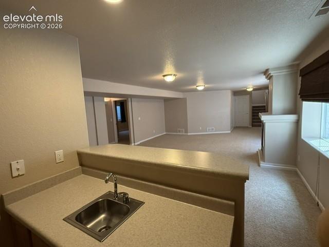 Image 18 of 24: wet bar viewing family room-note fireplace