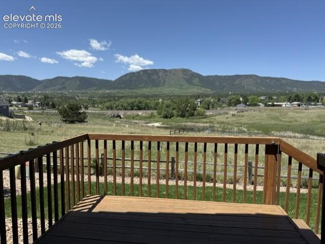 Image 5 of 24: Wood deck with mountain backdrop and natural landscape
