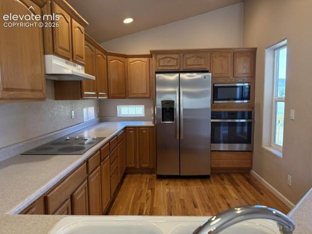 Image 8 of 24: Kitchen featuring wood cabinetry, stainless steel appliances, a built-in ov