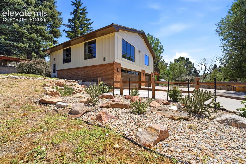 Image 2 of 50: Front Yard with Perennials and Cactus Garden