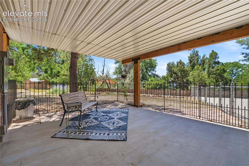 Image 36 of 50: Lower covered Patio with Private Entrance to Guest Quarters