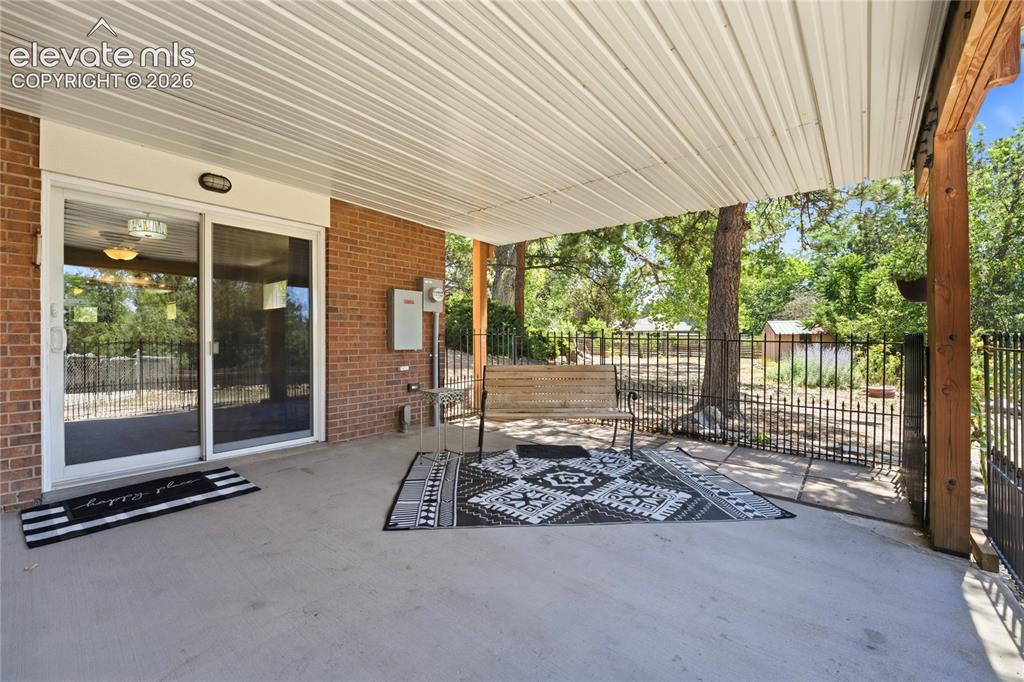Image 37 of 50: Lower covered Patio with Private Entrance to Guest Quarters