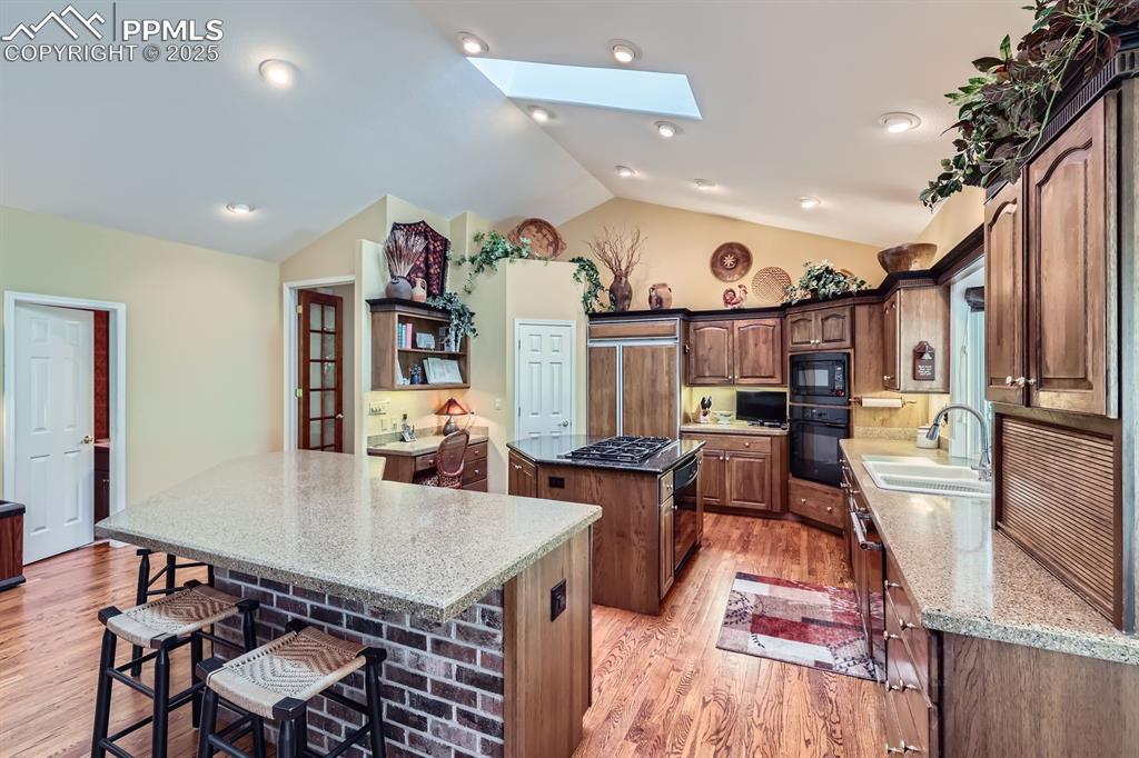 Image 19 of 49: Island with dacor 6 burner gas cooktop and oven, wall oven & microwave, lar