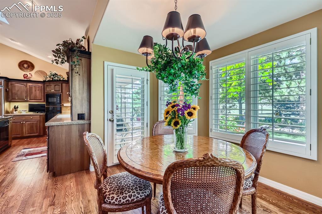 Image 20 of 49: Fabulous bay nook off of kitchen walk out to patio, custom shutters and vie