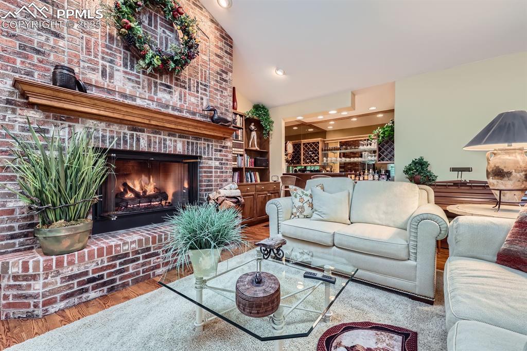 Image 25 of 49: Brick surround gas fireplace and hearth in family room