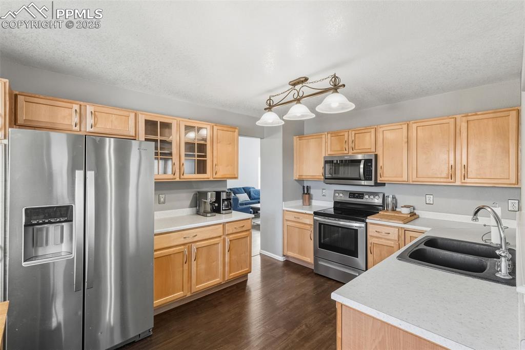 Image 15 of 34: Kitchen featuring stainless steel appliances, light brown cabinetry, light