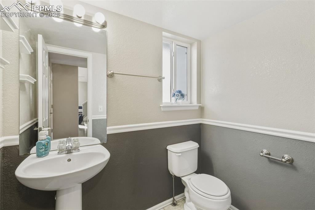 Image 19 of 34: Bathroom with a textured wall and toilet