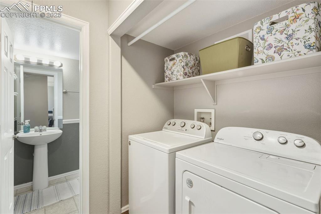 Image 20 of 34: Washroom with washer and dryer and baseboards
