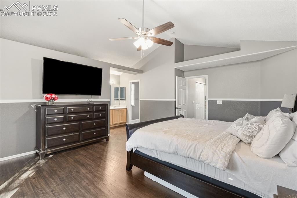 Image 24 of 34: Bedroom featuring dark wood finished floors, high vaulted ceiling, a ceilin