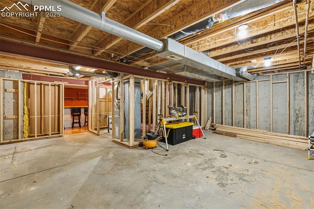 Image 32 of 34: Unfinished below grade area with heating unit