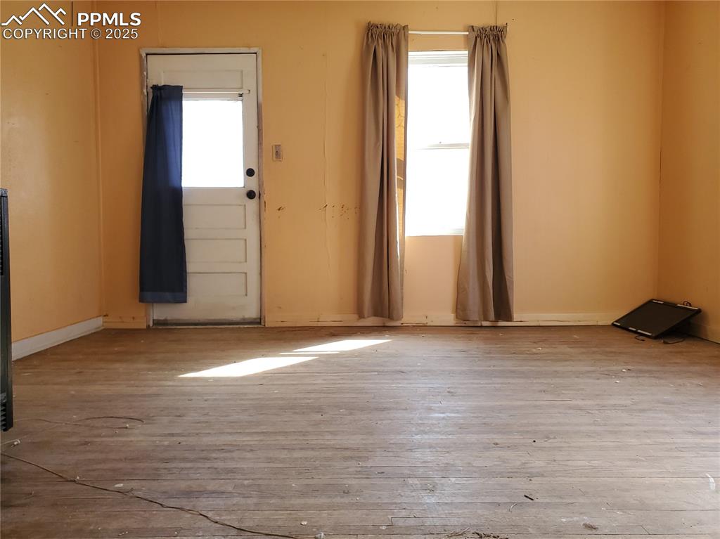 Image 4 of 28: Living Room (Looking From Kitchen into Living Room & Front Door)