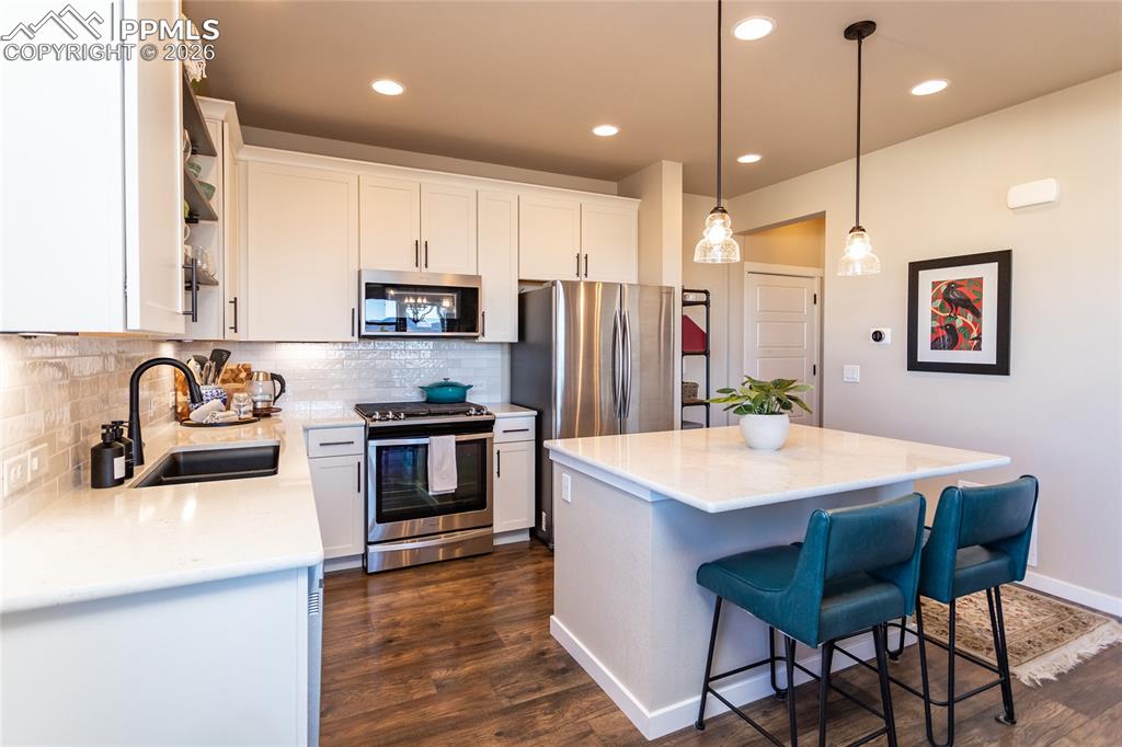 Image 9 of 36: Custom Quartz Countertops & Gas Range