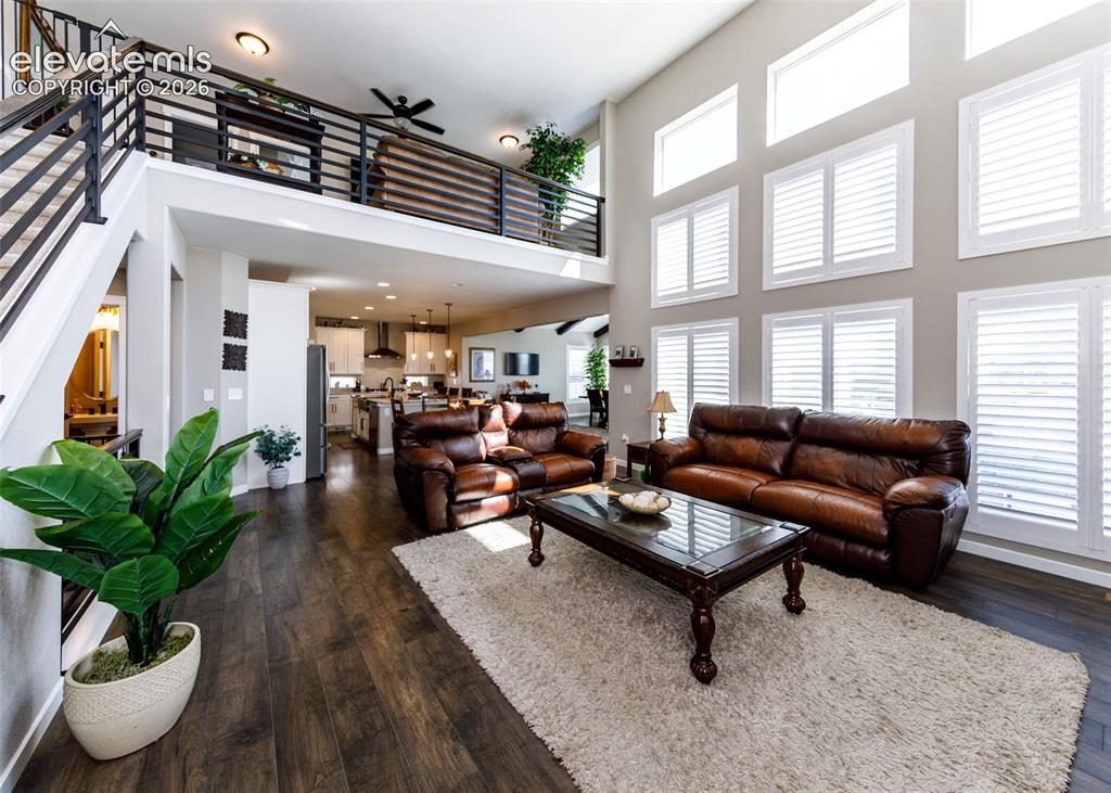 Image 10 of 50: Hardwood-finish flooring throughout, two-story ceiling with transom windows