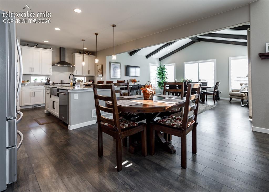 Image 11 of 50: Open-concept interior featuring wood-finish flooring, a kitchen island with