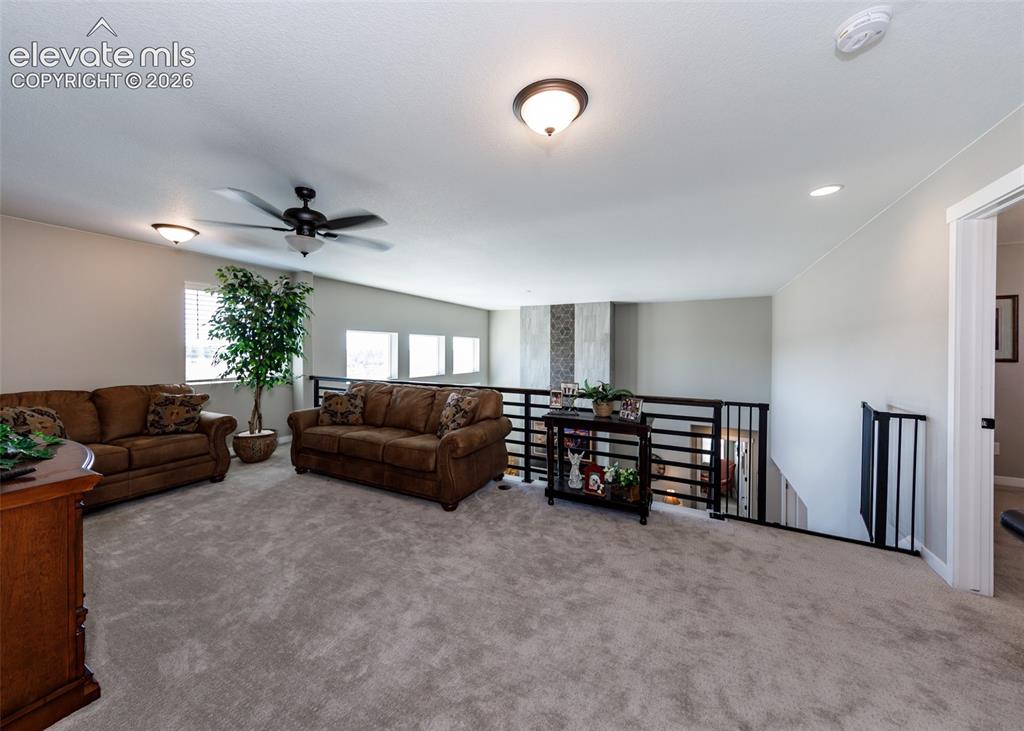 Image 28 of 50: Spacious carpeted loft area with a ceiling fan, recessed lighting, and mult