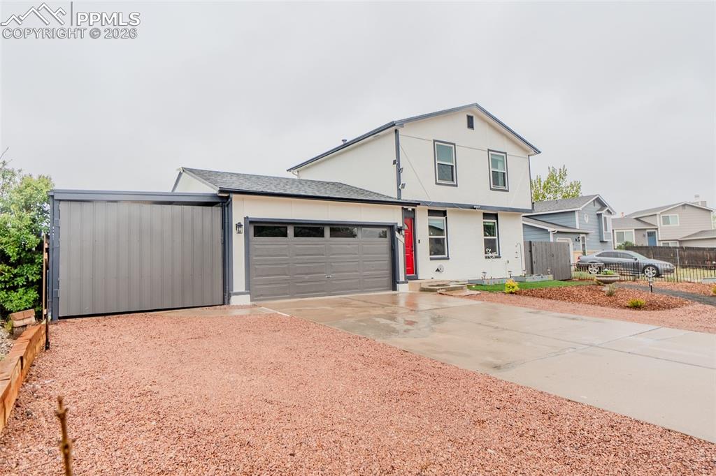 Caption: Contemporary two-story residence with fresh white paint, contrasting dark trim. 