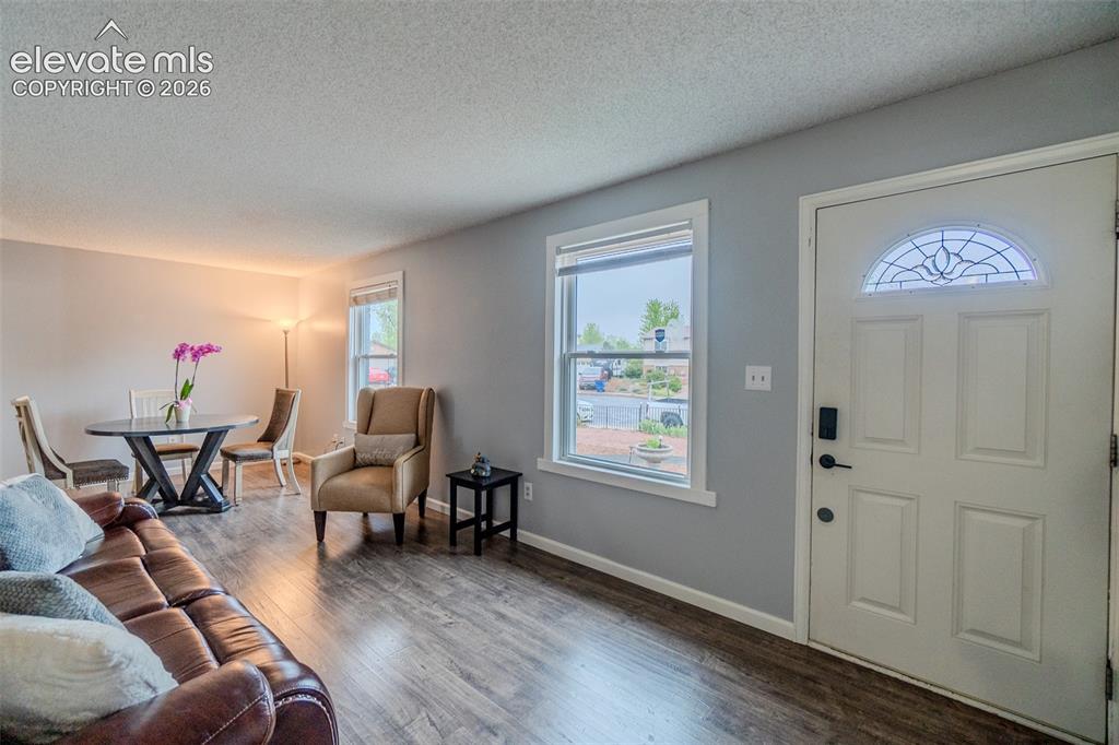 Image 5 of 33: Entryway featuring natural light, a white paneled door with a decorative ar