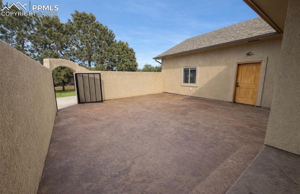 Image 3 of 31: Fully enclosed front patio with beautifully stained concrete.