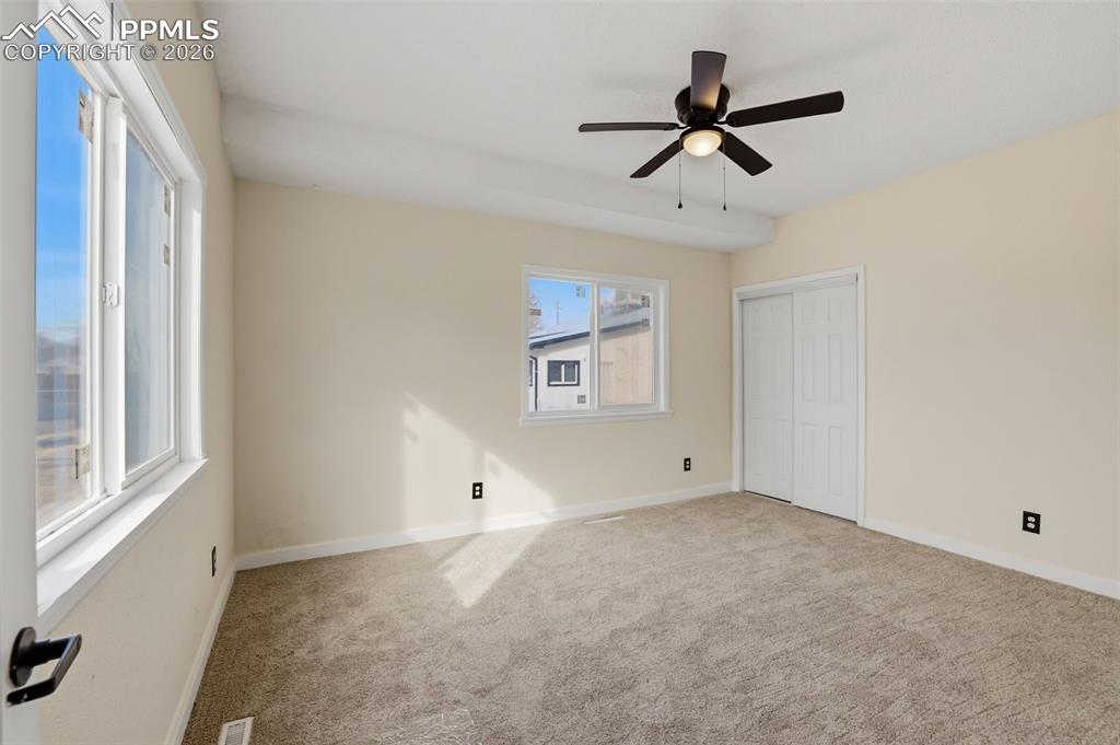 Image 17 of 36: Unfurnished bedroom featuring light colored carpet, a closet, and ceiling f