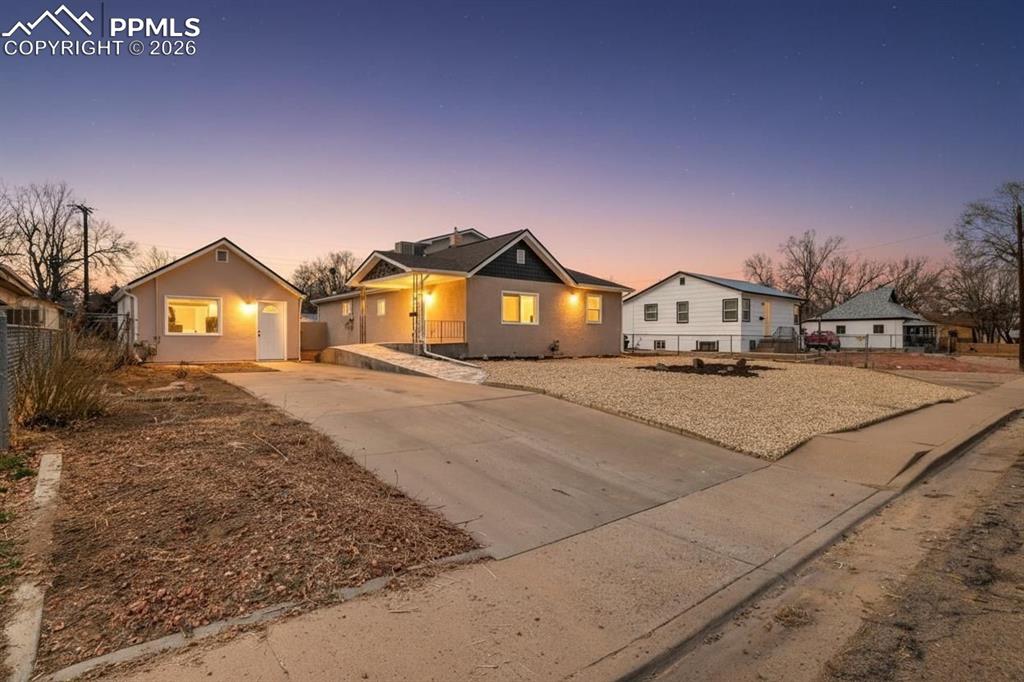 Image 2 of 36: View of front of house with concrete driveway and a residential view