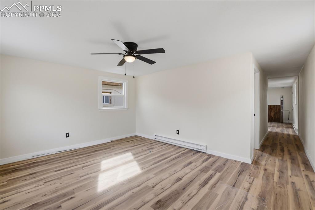 Image 26 of 36: Unfurnished room with a baseboard heating unit, light wood finished floors,