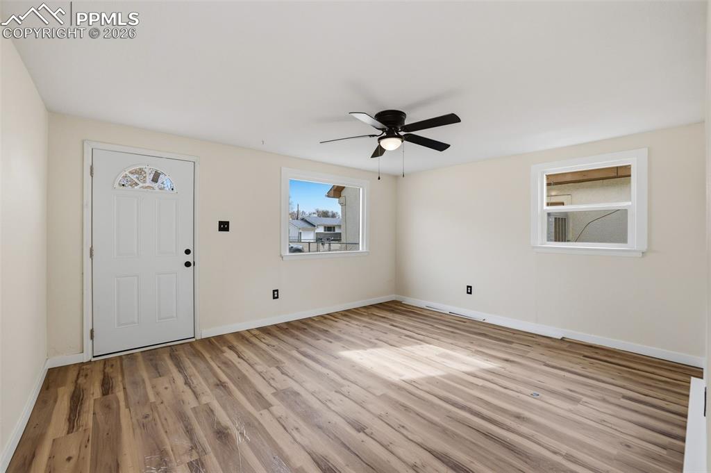 Image 27 of 36: Entryway with ceiling fan and light wood-style flooring
