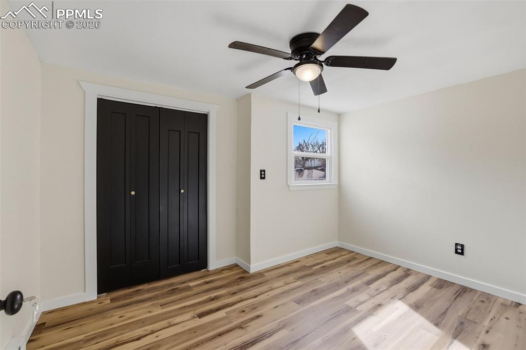 Image 28 of 36: Unfurnished bedroom featuring a closet, light wood finished floors, and cei