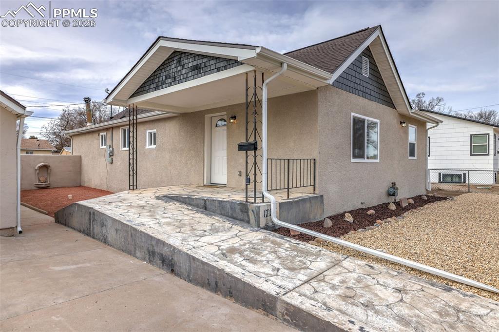 Image 4 of 36: Bungalow-style home featuring covered porch and stucco siding