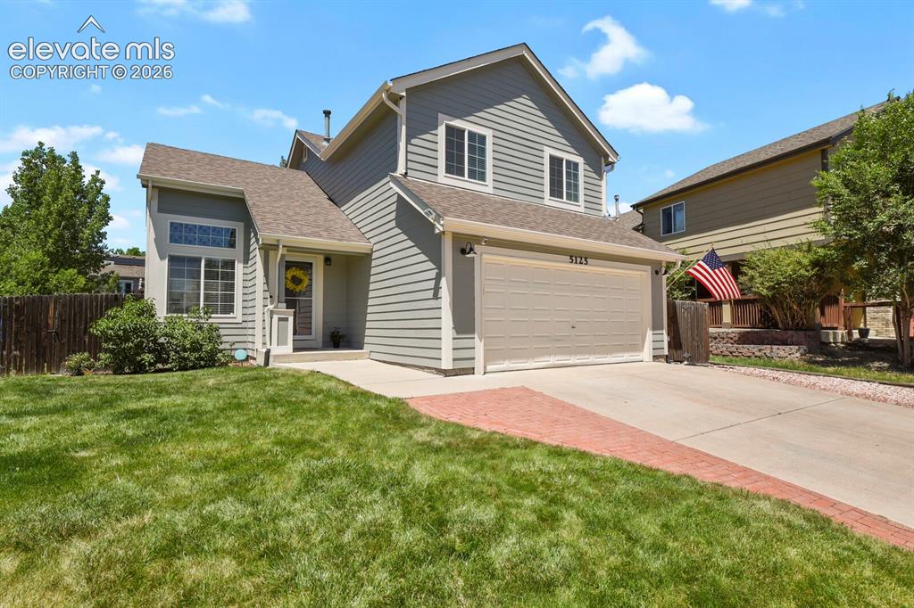 Image 1 of 46: Two-story property featuring light gray horizontal siding and a two-car gar